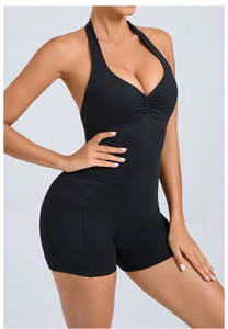 Detail of black backless halter yoga bodysuit featuring side pockets and a slim waist design
