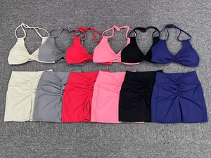 Detailed flat lay of yoga sets in six colors featuring halter tops and ruched shorts