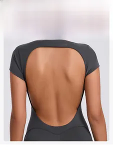 Detail of dark grey backless yoga bodysuit highlighting the sculpted open back design