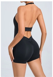 Detail of the back view of a black backless halter yoga jumpsuit with scrunch butt design