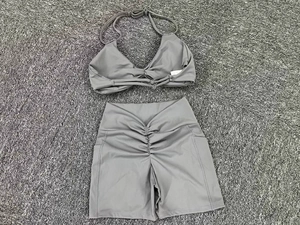 Flat lay of grey yoga set with halter sports bra and high-waisted scrunch shorts