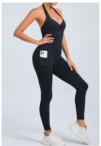 Detail shot of black yoga jumpsuit showing side pockets for holding a smartphone