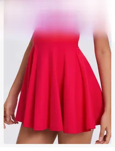Detail of red pleated athletic dress featuring built-in safety liner and shaping hem