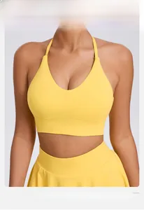 Detail of a bright yellow yoga sports bra with adjustable straps and deep V-neckline
