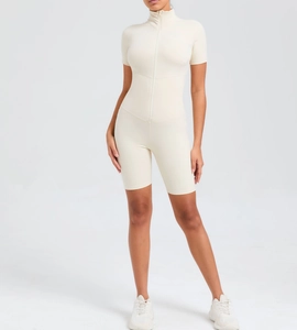 Detail of cream short sleeve yoga jumpsuit with front zipper and high collar neck design