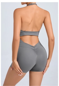 Detail view of backless halter yoga jumpsuit with pockets and high waist lift