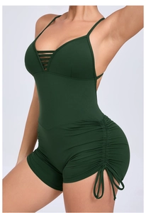 Detail of dark green yoga jumpsuit with side drawstring ruched texture and V-neck straps