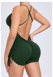 Detail view of the open back with cross straps and side drawstrings on green yoga jumpsuit