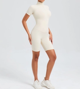 Close-up of beige athletic bodysuit featuring front zipper and tummy control stitching