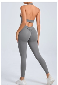 Detailed back view of a dark grey halter neck yoga jumpsuit with scrunch butt detailing