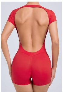 Macro view of the deep U-shaped backless design on this red yoga bodysuit