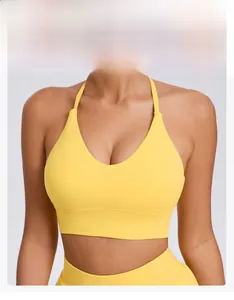 Detail of yellow U-neck sports bra featuring adjustable halter straps and supportive fit