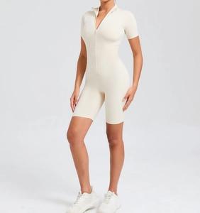 Detail of a slim-fit yoga bodysuit in cream white with a front zipper and high collar