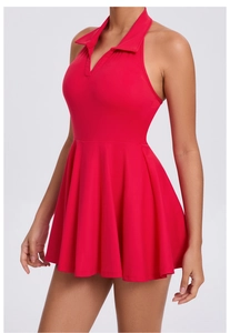 Close-up of red athletic tennis dress with halter lapel collar and pleated skirt detail