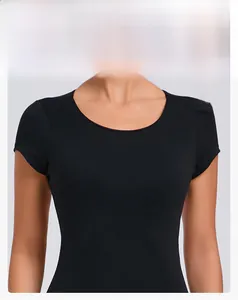 Detail showing the round neckline and slim fit design of this black athletic yoga top