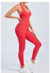 Detail of red halter yoga bodysuit featuring side pockets and high-stretch fabric texture