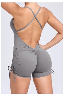 Detail of cross-back straps and scrunch butt design on grey yoga bodysuit