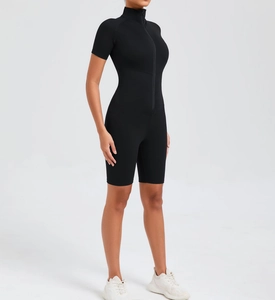 Close-up detail of black yoga jumpsuit with front zipper and short sleeve bodycon fit