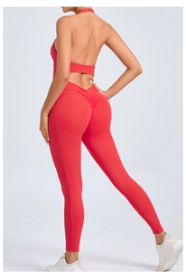 Detail of red backless halter yoga jumpsuit featuring ruched butt-lifting seam and fit