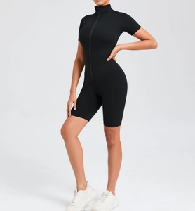 Close-up of black short sleeve yoga jumpsuit with front zipper and stand collar detail