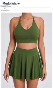 Detail of army green two-piece athletic set featuring V-neck bra and pleated skirt