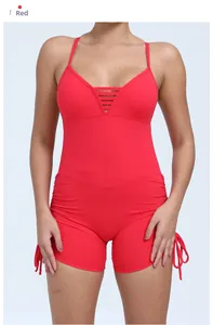Detail of red hollow back yoga bodysuit with side drawstring and ribbed elastic fabric