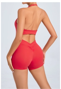Close-up of red backless yoga bodysuit featuring halter neck and scrunch butt detail