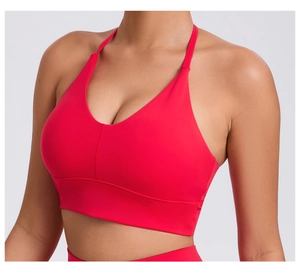 Detail view of red yoga bra with adjustable straps and wide hem band for stability