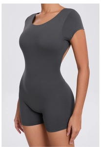 Detail view of deep grey open back yoga jumpsuit with ergonomic stitching and elastic fabric