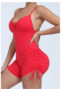 Detail view of red yoga bodysuit featuring side drawstrings and backless design
