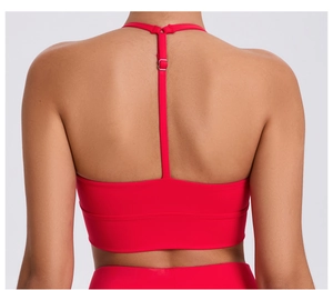 Detail view of red sports bra with racerback adjustable thin straps and metal buckle