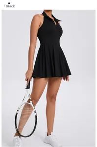 Detailed back view of a black athletic tennis dress with halter neck and pleated hem