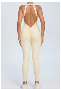 Close-up of open-back cutout and ruched peach butt detail on cream yoga bodysuit
