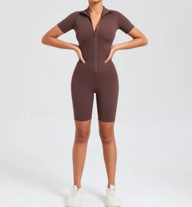 Close-up of slim-fit brown yoga bodysuit featuring front half-zipper and short sleeves