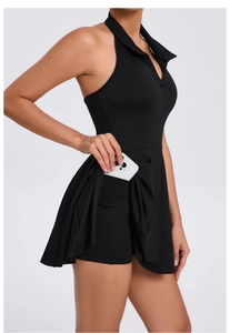 Detail of hidden side pocket on black athletic dress featuring a white smartphone inside