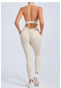 Detailed back view of a beige backless yoga jumpsuit with flattering scrunch butt seam