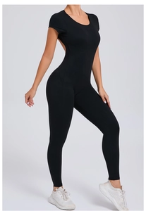 Detail of black open back yoga jumpsuit showing sleek fabric and slim fit on model