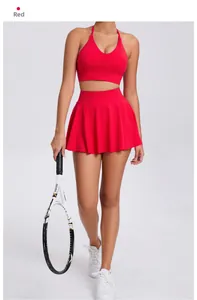 Detail of red sports bra and pleated tennis skirt set with a tennis racket