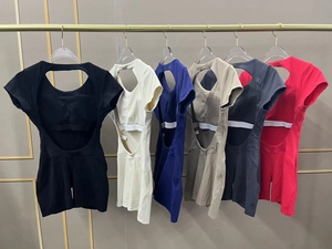 Selection of open-back athletic bodysuits in six colors on golden garment hangers