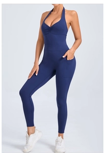 Detail view of navy blue halter yoga jumpsuit with side pockets and open back design