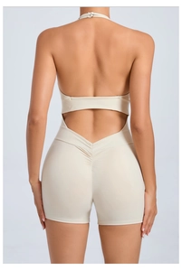Macro view of back ruched detail and seamless lifting design on beige yoga jumpsuit