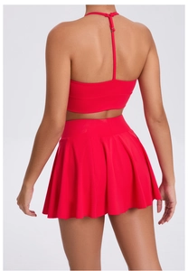 Detail of red two-piece sports set with pleated skirt and adjustable racerback bra