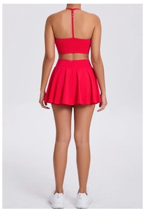 Back view of high-elastic red sports bra and pleated tennis skirt two-piece gym set