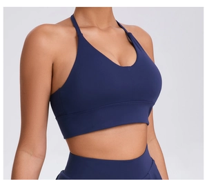 Detail of navy blue sports bra fabric showing adjustable straps and high-elastic texture