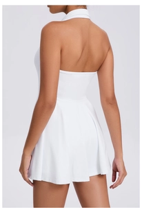 Back view of a white halter tennis dress featuring a pleated A-line skirt and racerback