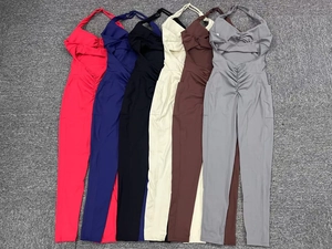 Detailed flat lay of six colorful halter neck yoga jumpsuits with side pockets and ruching