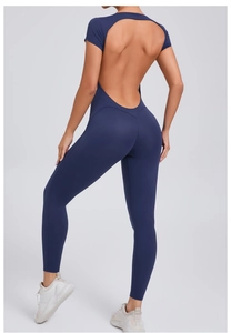 Detail view showing deep blue open back design of tight yoga bodysuit for fitness