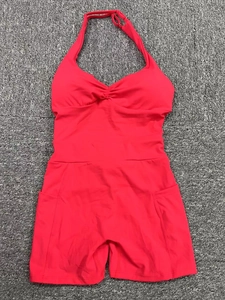 Flat lay of red backless yoga bodysuit with halter neck V-neckline and side pockets