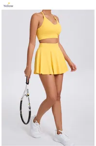 Detail view of bright yellow tennis set featuring pleated skirt and racerback sports bra