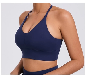 Detail view of dark blue sports bra showing adjustable straps and high elastic fabric